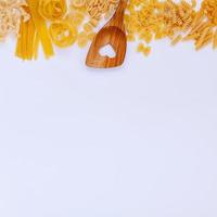 Pasta and wooden spoon with copy space photo