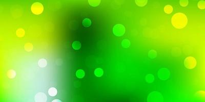 Light green, yellow vector background with spots.