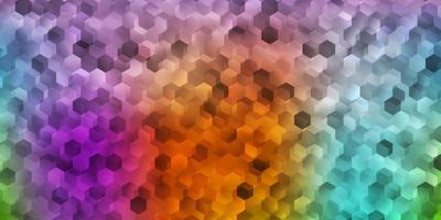 Fondo de vector multicolor claro con formas hexagonales.