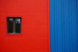 Window on the red facade of a house photo