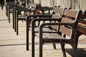 Wooden bench on the street photo