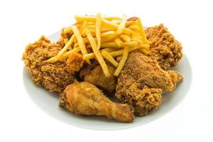 Fried chicken and french fries on a white plate photo