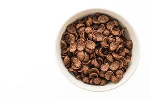 Chocolate cereals in white bowl photo