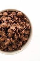 Chocolate cereals in white bowl photo