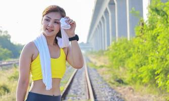 Beautiful woman exercises outdoors in the park photo