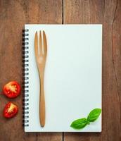 Notebook mock-up with tomatoes and basil photo