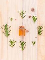 Rosemary essential oil on wood photo