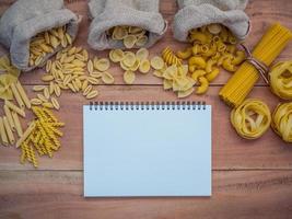 Blank notebook and dried pastas photo