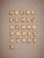 Alphabet cookies on a brown background