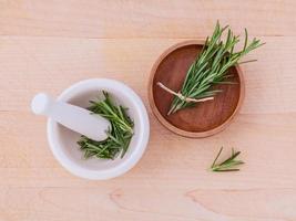 Top view of rosemary in a mortar and bowl photo