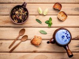 Herbal tea pot with fresh herbs top view photo