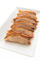 Grilled duck meat on white plate photo