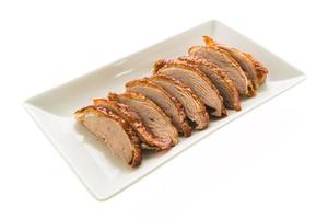 Grilled duck meat on white plate photo