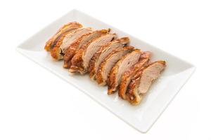 Grilled duck meat on white plate photo