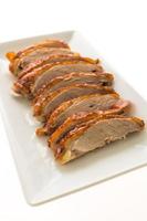 Grilled duck meat on white plate photo