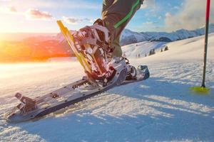 Walking with snowshoes in the mountains photo