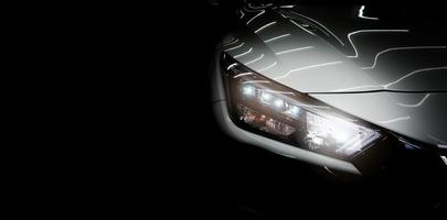 Car headlight and isolated on black photo