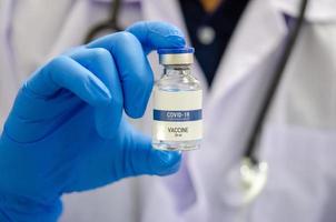 Doctor holding a COVID vaccine photo