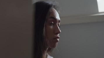 Close up, profile of young mixed race woman, looking straight ahead, eyes blinking video