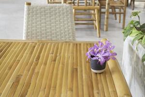 Bamboo furniture with purple flower arrangement