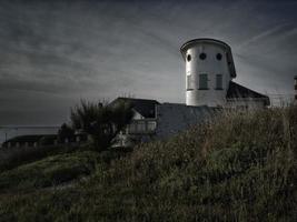 Rationalist house in a coastal town at sunset photo