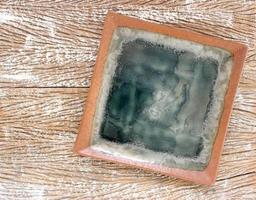 Top view of an empty ceramic plate on a wood table background photo