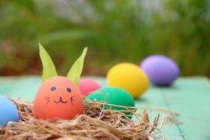 Easter eggs in a nest on a wooden background