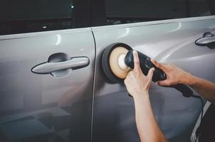 Man buffing a gray car photo