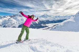 Young girl on skis in winter mountain resort photo