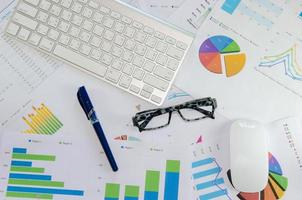 Glasses with desk items on documents photo