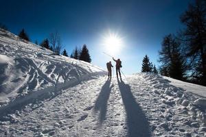 Alpine skiers uphill photo