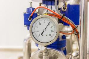 Close-up of pressure gauge, pipes and valves at pharmacy industry manufacture factory photo