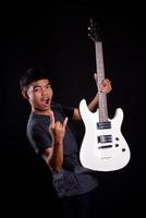 Young man with electric guitar in studio photo