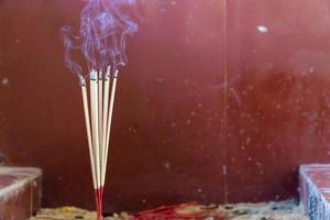 Close-up of burning incense sticks with smoke
