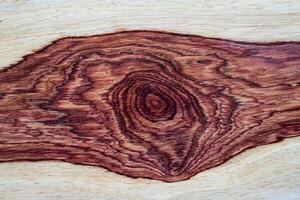 Natural Afzelia burl wood pattern texture background photo