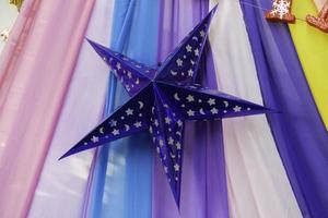 Blue star decoration with colorful fabric background photo