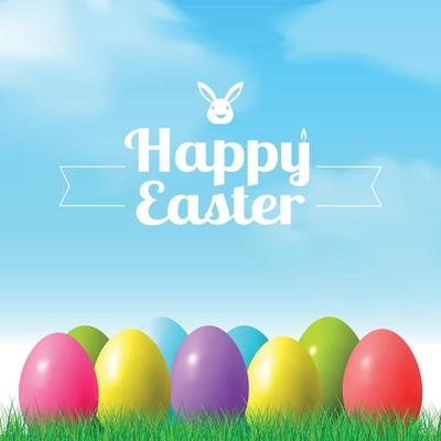 Abstract Easter bokeh background with colorful eggs lying on the grass against the sky background