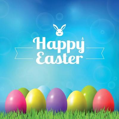 Abstract Easter bokeh background with colorful eggs lying on the grass against the sky background
