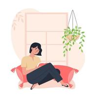 Young woman sitting by the window and reading a book, relaxing at home vector