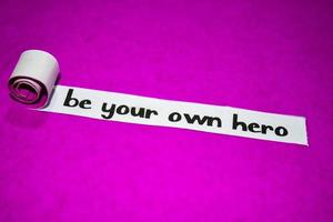 Be your own hero text, Inspiration, motivation and business concept on purple torn paper photo