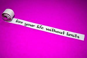 Live your life without limits text, Inspiration, Motivation and business concept on purple torn paper photo