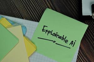 Explainable AI written on sticky note isolated on wooden table photo