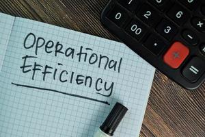 Operational Efficiency written on book isolated on wooden table photo