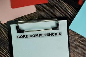 Core Competencies written on paperwork isolated on wooden table photo