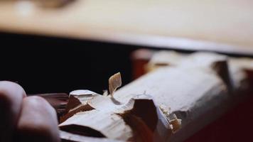 woodcarvers carve the legs on a wooden stand using a chisel video