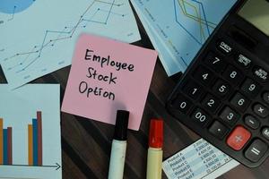 Employee Stock Option written on sticky note isolated on wooden table photo