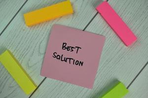 Best Solution written on sticky note isolated on wooden table photo