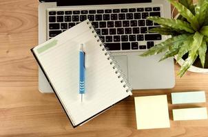 Notebook and laptop on a desk photo