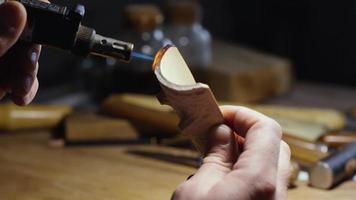 man burns a wooden with a burne video