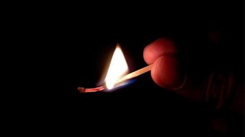Matchstick with the flame and smoke burning, isolated on a black background photo